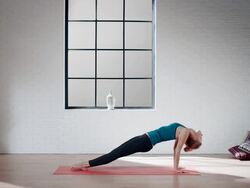 Woman practicing yoga in gym (inclined plane pose) Stock Footage