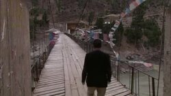 Prayer flags flutter on a footbridge. Stock Footage