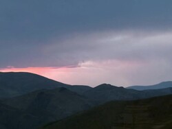 R-L Pan of dark mountains with dramatic cloudy and red sky, Oruro mountain range, Bolivia Stock Footage