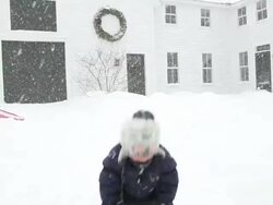 MS Boy playing with snow during snowstorm  / Yarmouth, Maine, USA Stock Footage