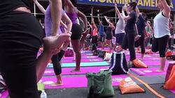 CLEAN : Thousands of yogis hit Times Square to welcome summer News Clip