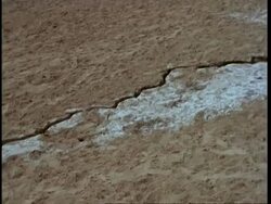 MS pan right, along crack in ground, salt deposits, Gujarat, India Stock Footage