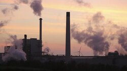 Sunset over the Iggesund paper board manufacturer in Workington, Cumbria, UK, at sunset, with wind turbines. The plant is powered by a biofuel power station, on site. Stock Footage