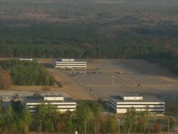 MS AERIAL DS Shot of empty parking area at Savannah River Nuclear sites (four inactive) / South Carolina, United States Stock Footage