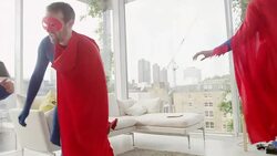 Superhero family playing in living room Stock Footage