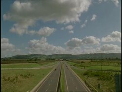 T/L WA high angle view of traffic on A 417, Gloucestershire, through countryside (Driving on left hand side of road) Stock Footage