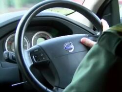 Paramedic Driving an Ambulance with Sirens on News Clip