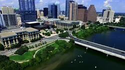 Over Lady Bird Lake Looking down on Paddle Boarders and Kayakers in Austin Texas Capital City Stock Footage