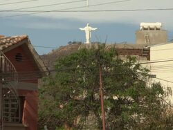 Residential roofs with Cristo De La Concordia on San Pedro Hill in b/g, from Av Salamanca, Cochabamba, Bolivia Stock Footage