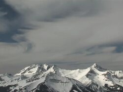 MS T/L View of Clouds and Snow Rolling over Majestic Mountain Peaks in evening Light / Telluride, Colorado, United States Stock Footage