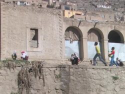 WS ZO View of school children walking near clay building in village / Kabul, Kabul Province, Afghanistan Stock Footage