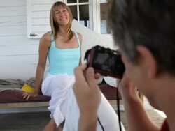 woman poses for holiday snaps sitting outside beach house/Tarifa/Andalucia/Spain Stock Footage