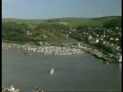 T/L WA high angle view of River Dart leading out to sea, Pan left to Kingsbridge Town, Dartmouth, boats and ferries on river and in harbour Stock Footage