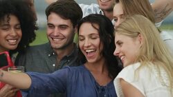 Enthusiastic friends taking self-portrait with camera phone Stock Footage