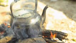 panning: Steaming tea kettle  by traditional method Stock Footage