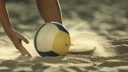 HD Super Slow-Mo: Beach Volleyball Player Picking Up A Ball Stock Footage
