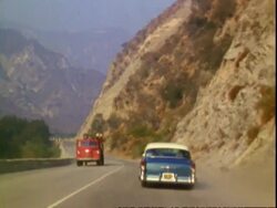 1950s car driving through Angeles National Forest Stock Footage