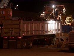CU of truck driving into plant with a trailer full of sugar beets. Stock Footage