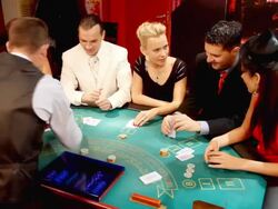 Croupier passing cards to blackjack gamblers in casino. Stock Footage