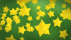 Yellow star fruits float forward past a green background. Stock Footage
