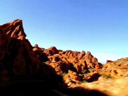 POV driving on two lane desert road through red rocks of Aztec sandstone in Valley of Fire / Overton, Nevada, USA Stock Footage