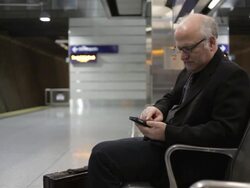 MS Middle aged businessman using cellular phone inside commuter transit station / Minneapolis, Minnesota, United States Stock Footage