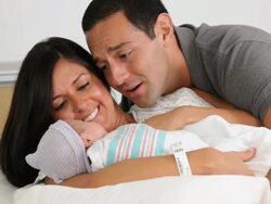 MS PAN Mother and Father with Newborn Laying in Hospital Bed / Richmond, Virginia, USA Stock Footage
