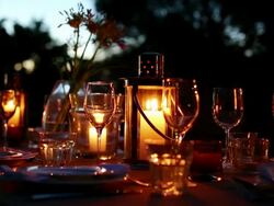 Table with luxury place settings in backyard at night Stock Footage