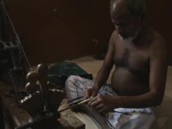 WS Man spinning thread on spinning wheel / India Stock Footage