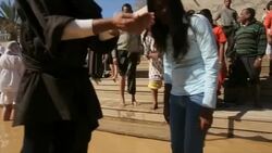 Orthodox Christian pilgrims baptised in Jordan River Stock Footage