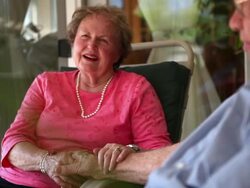 A shot of an elderly man and woman laughing as they tell a story. Stock Footage