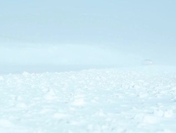 Winter Blizzard with Blowing Snow Across Highway and Car Stock Footage