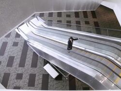 HA Businesswoman ascending escalator in building / Seattle, Washington, United States Stock Footage