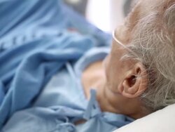 Senior Patient in bed breathing oxygen mask Stock Footage