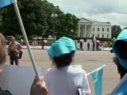 2009 MS TU TD Protestors in front of the White House shouting slogans and holding blue Uygur flags during an anti-China protest in support of the Uygurs/ Washington D.C., USA/ AUDIO Stock Footage
