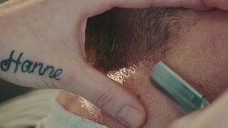 Barber shaving beard with razor Stock Footage