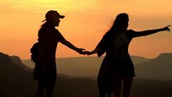 Silhouette couple's holding hand for travelers on sunrise Stock Footage