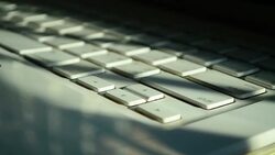 Time-lapse: Laptop Computer Keyboard with Sunlight from the Window Stock Footage