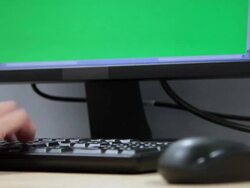 Hand typing keyboard and green screen moniter Stock Footage