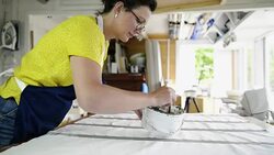 Woman painting on textile Stock Footage
