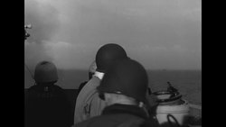 Naval officers on boat look through binoculars to scan ocean during World War II News Clip