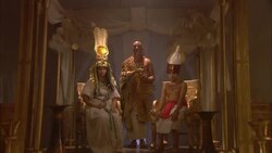 A priest in a leopard skin robe holds incense as he leads Egyptian royalty away from a throne. Stock Footage