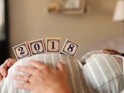 A pregnant women using blocks to spell the word 2018 on her stomach. Stock Footage