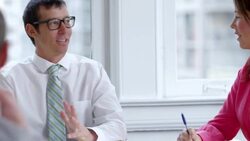 MS Smiling businessman leading team meeting with coworkers in office Stock Footage