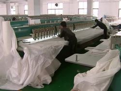 Textile workers in large textile factory News Clip