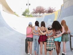 Teenage girls in a row at skateboard park Stock Footage