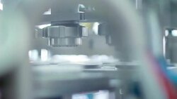 Yogurt is poured into package. Dairy product at production line. Packaging process of yogurt in the plastic container. Food packaging line at dairy factory. Production line at food processing plant. Industrial equipment at food factory. Packing machine Stock Footage