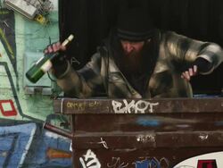 MS Homeless man with wine bottle exiting garbage container, Salt Lake City, Utah, USA Stock Footage