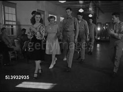 1946: RED CROSS: RECREATION: DANCING:  WS Female Red Cross workers in dance hall w/ veteran soldiers, teaching them how to dance, step in pace, female holding two male soldiers' hands, stepping back & forth. Instructional Video
