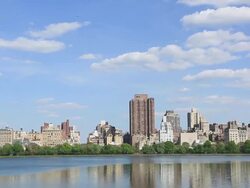WS PAN View of Clouds over fresh green trees and Central Park East Residences at Reservoir / New York, United States  Stock Footage